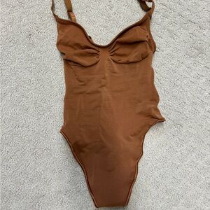 Skims seamless sculpt thong bodysuit in bronze